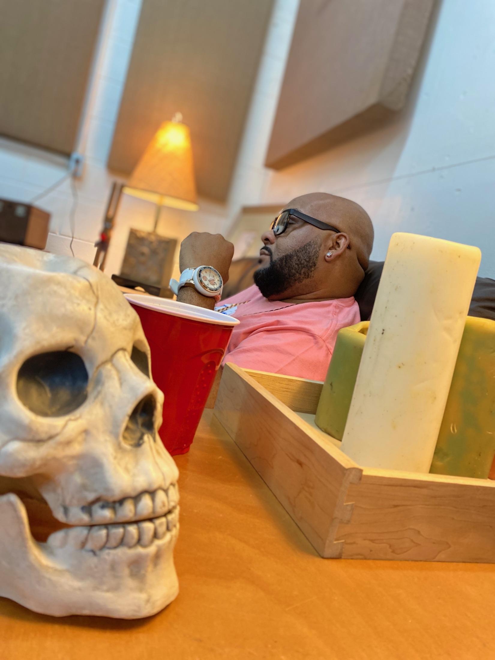 Boogie Taylor in a low-lit lounge behind a skull sculpture
